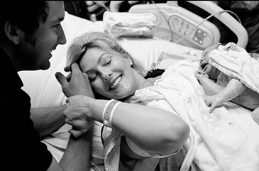 Mother and father with newborn baby - just born.