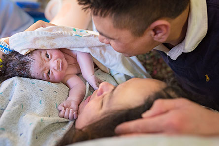Mother and father with newborn baby - just born