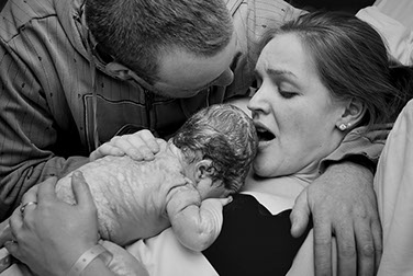 mother and father with newborn baby - just born.