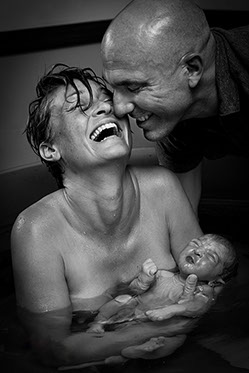 Mother and father with neworn baby after water birth