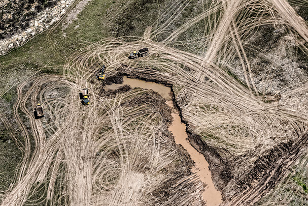 Aerial photo of vehicle tracks at oil drilling site.